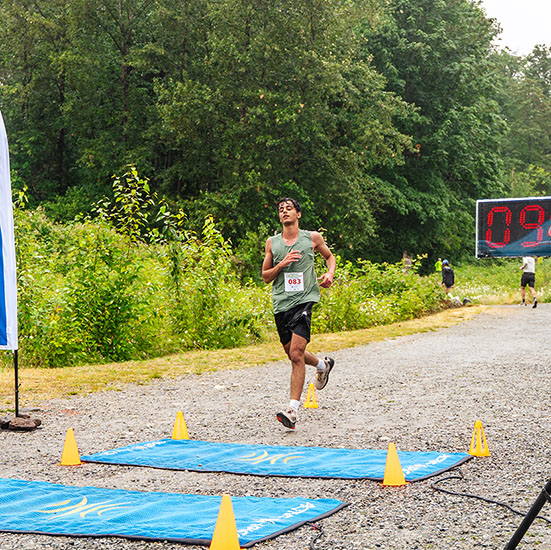 Participant of the coquitlam crunch challenge 8km run crossing the timing mats